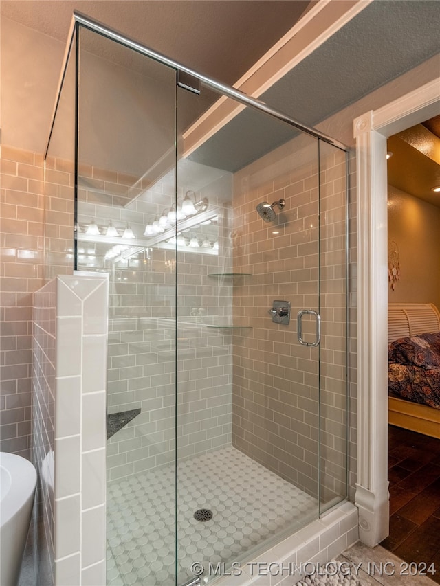 bathroom featuring walk in shower and wood-type flooring