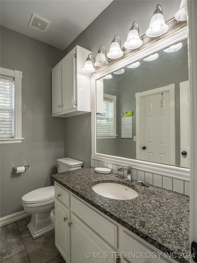 bathroom with vanity, toilet, and tile patterned floors