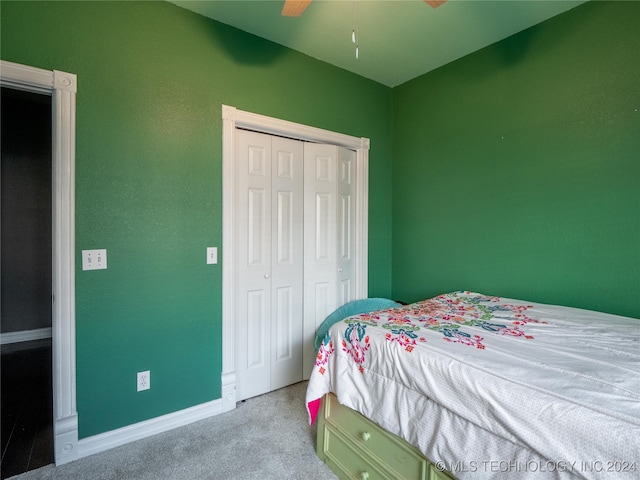 bedroom featuring a closet, ceiling fan, and light colored carpet