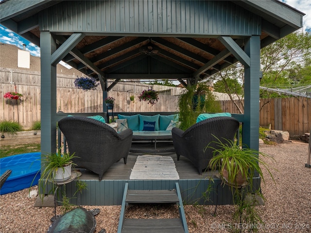 exterior space with a gazebo, a deck, and an outdoor hangout area