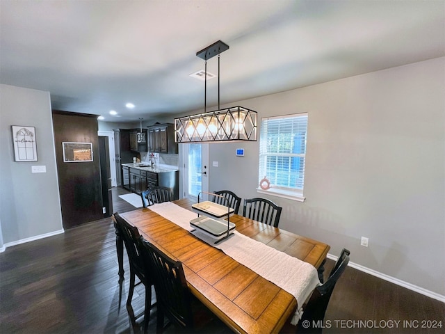 dining room with dark wood-type flooring and sink