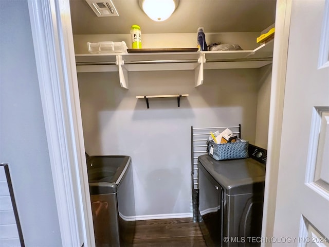 laundry room featuring dark hardwood / wood-style floors and separate washer and dryer