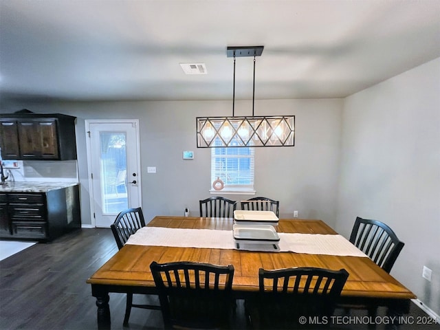 dining area with dark hardwood / wood-style flooring