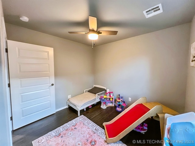 bedroom with ceiling fan and dark hardwood / wood-style floors