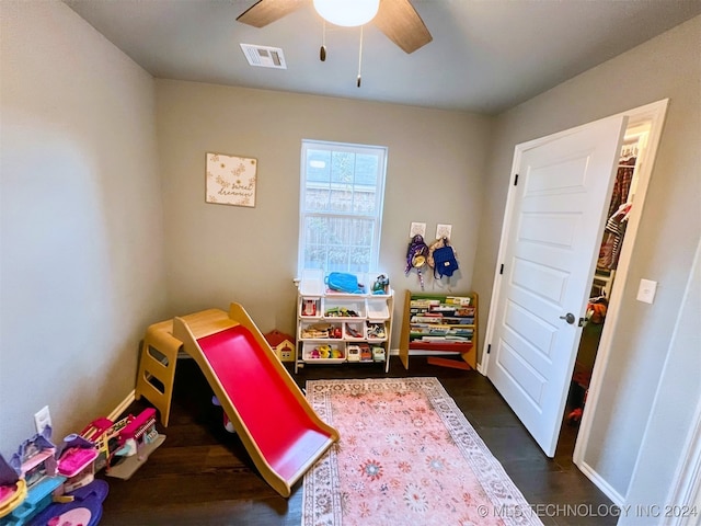 game room with dark hardwood / wood-style floors and ceiling fan