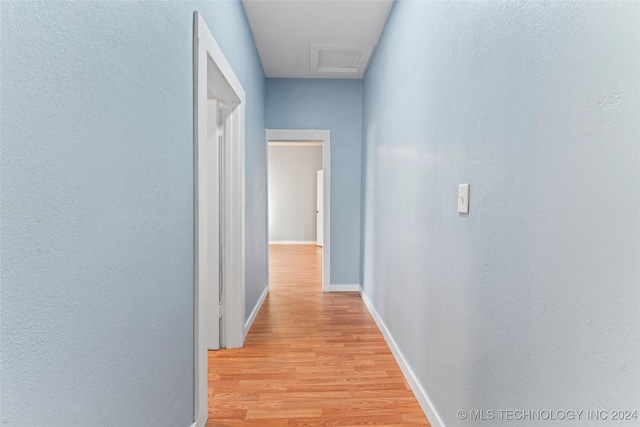 corridor with light wood-type flooring
