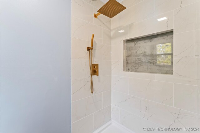 bathroom with tiled shower