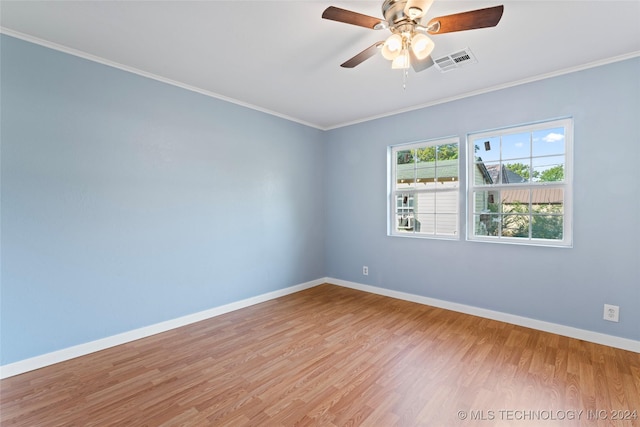 spare room featuring ceiling fan, light wood-type flooring, and crown molding