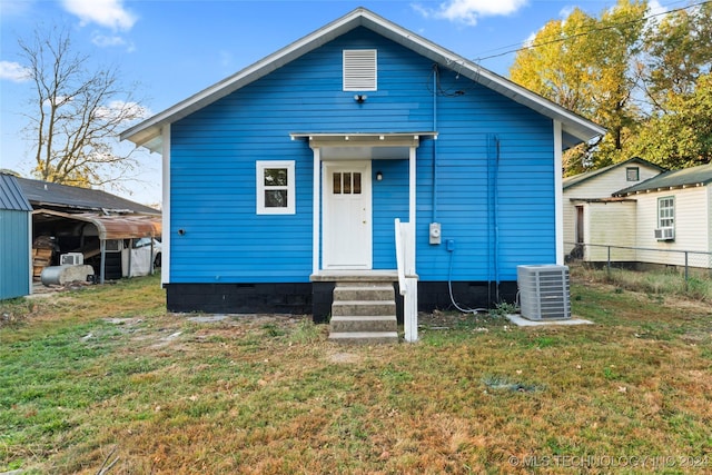 back of house with a yard and cooling unit