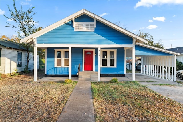 bungalow featuring a carport and a porch