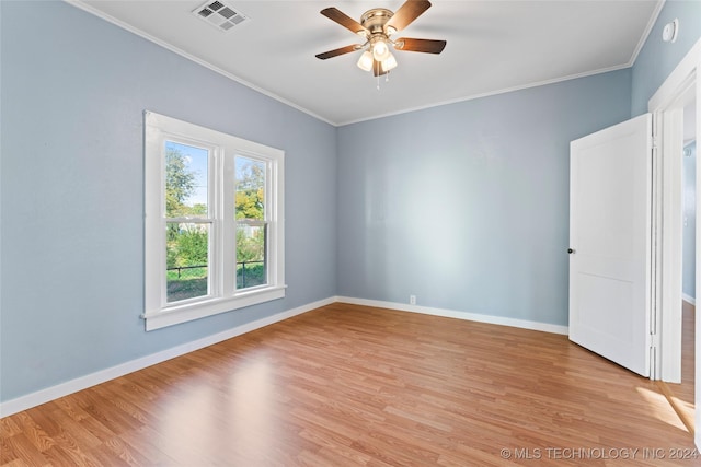 empty room with ceiling fan, crown molding, and light wood-type flooring