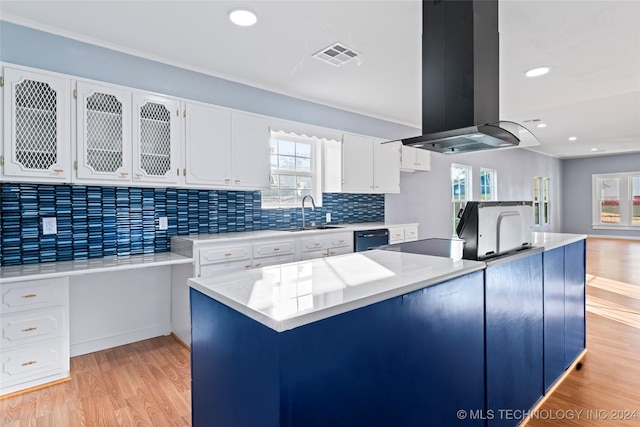 kitchen with white cabinetry, sink, black dishwasher, light hardwood / wood-style floors, and island range hood