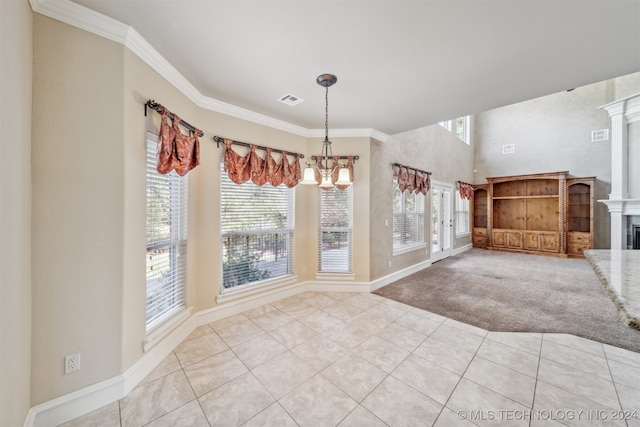 unfurnished dining area with light carpet, crown molding, a large fireplace, and a wealth of natural light