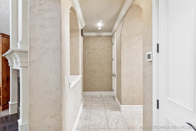 bathroom with crown molding and tile patterned flooring