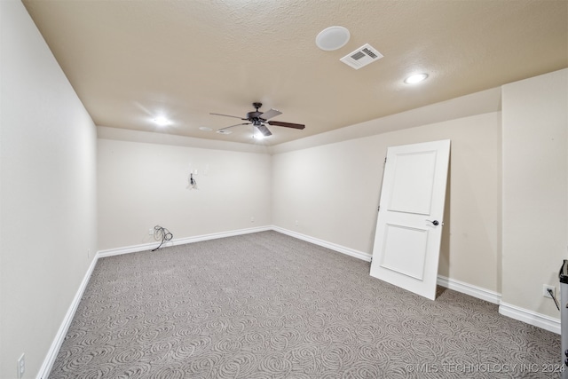 spare room with light carpet, a textured ceiling, and ceiling fan