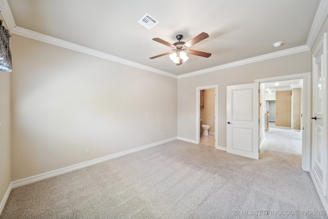 unfurnished bedroom featuring light carpet, ornamental molding, ceiling fan, and ensuite bathroom