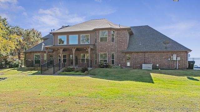 back of house featuring a lawn