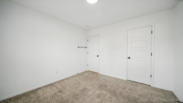 unfurnished room with carpet floors