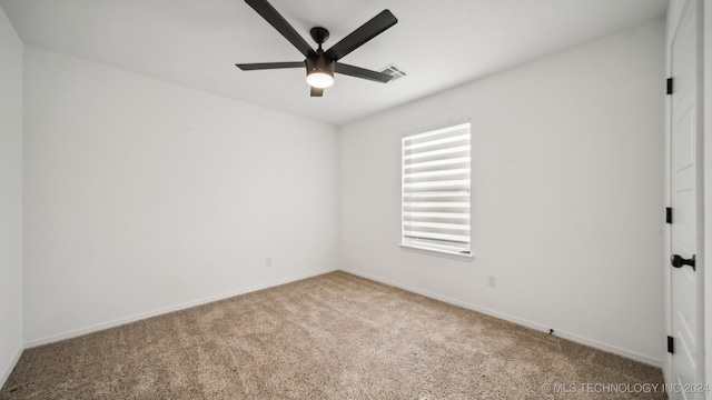 spare room with carpet flooring and ceiling fan