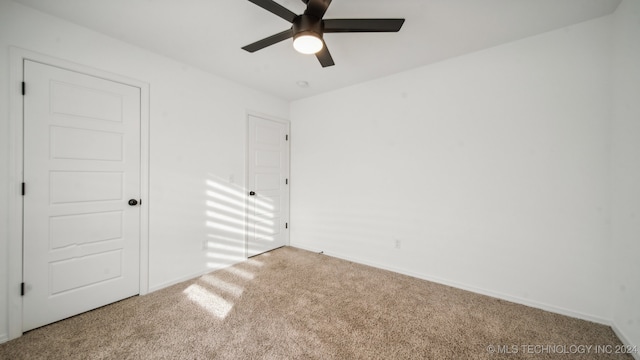 unfurnished bedroom featuring ceiling fan and carpet flooring