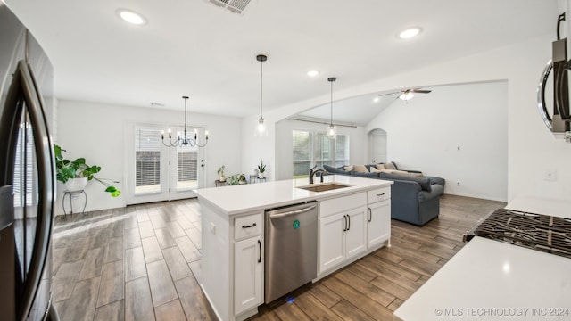 kitchen with appliances with stainless steel finishes, sink, an island with sink, white cabinetry, and dark wood-type flooring