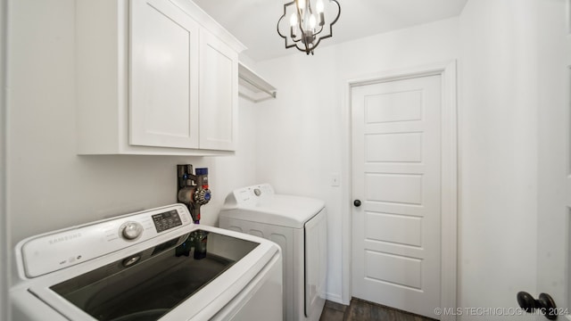 washroom with a chandelier, washer and clothes dryer, cabinets, and dark hardwood / wood-style flooring