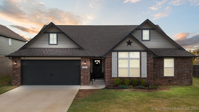 view of front of home with a yard and a garage