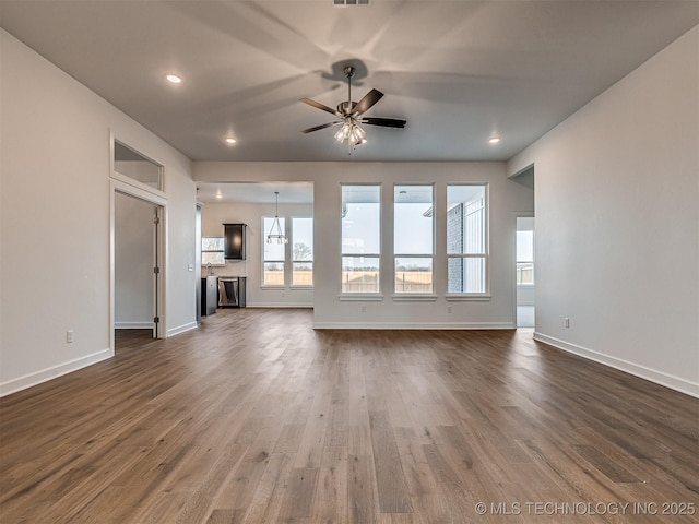 unfurnished living room featuring ceiling fan and dark hardwood / wood-style floors