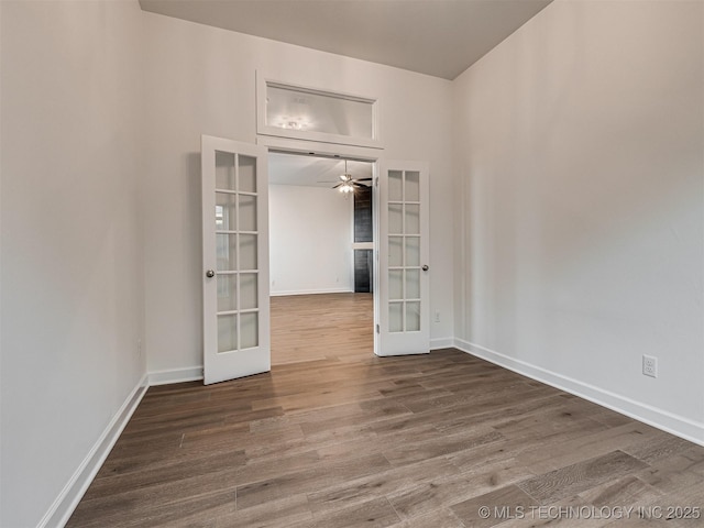 spare room featuring ceiling fan, french doors, and hardwood / wood-style floors