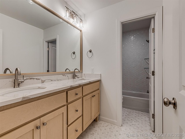 bathroom with vanity and tiled shower / bath