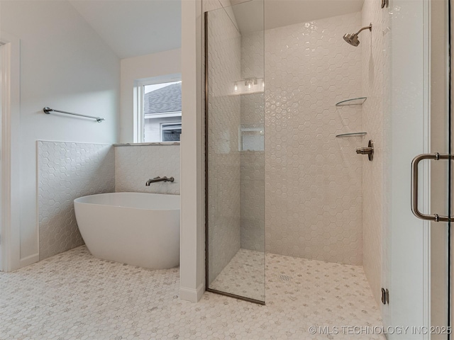 bathroom featuring separate shower and tub