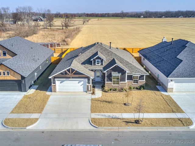 craftsman-style house featuring a rural view and a garage