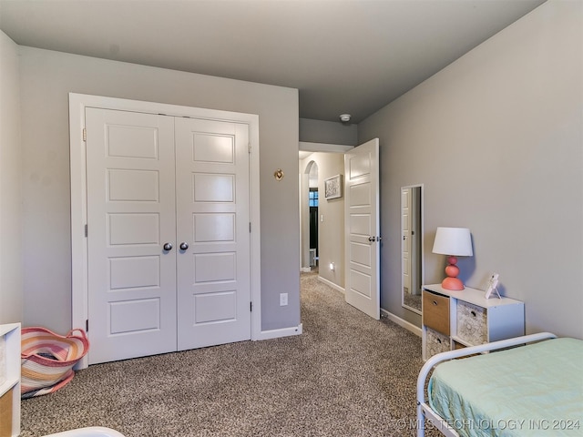 carpeted bedroom with a closet