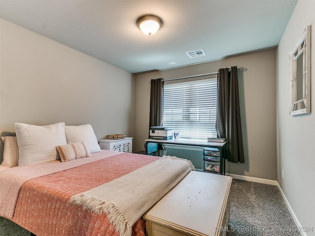 bedroom with dark colored carpet