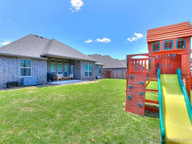 view of yard with a patio and a playground