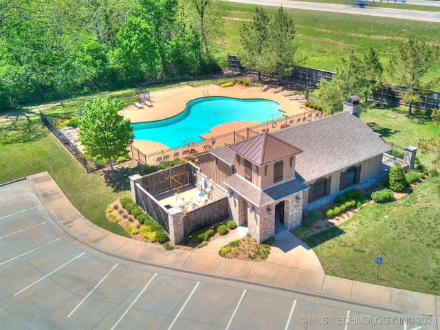 view of swimming pool featuring a patio and a lawn