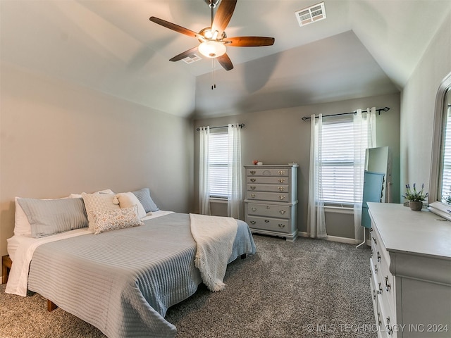 bedroom featuring dark carpet, lofted ceiling, and ceiling fan