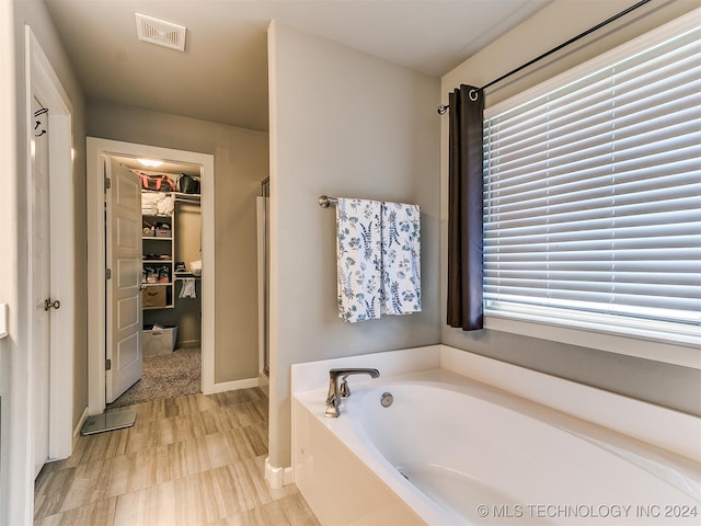 bathroom with plus walk in shower and plenty of natural light