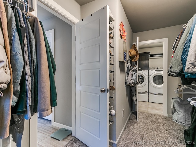 clothes washing area featuring independent washer and dryer and carpet