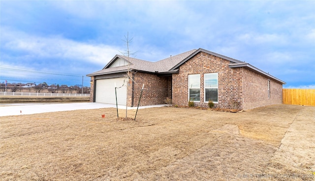 ranch-style home featuring a garage and a front yard