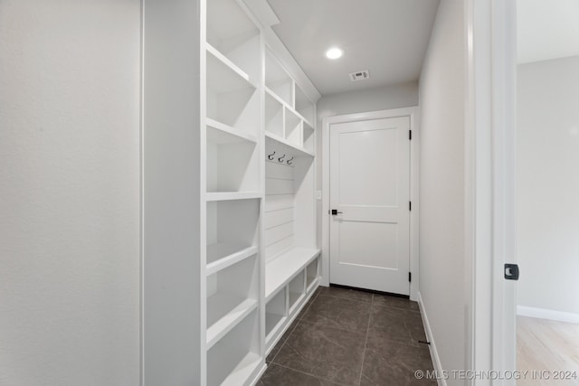 mudroom featuring dark tile patterned floors