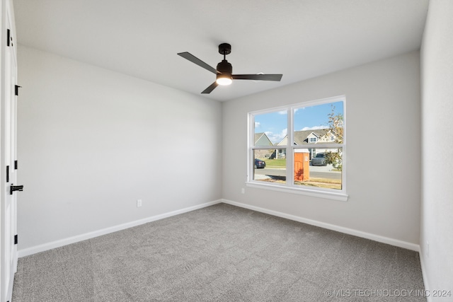 empty room featuring carpet flooring and ceiling fan