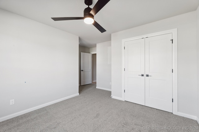 unfurnished bedroom with a closet, ceiling fan, and light carpet