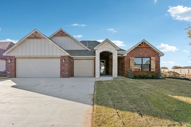 view of front of house featuring a front yard and a garage