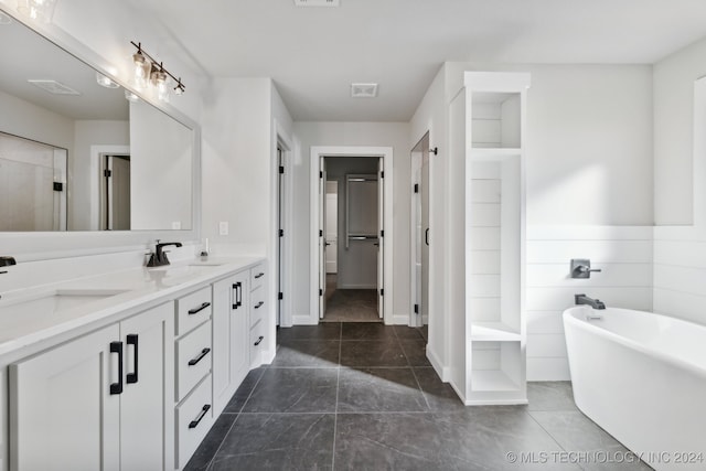 bathroom with vanity, tile patterned flooring, and a bathing tub