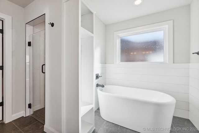 bathroom with independent shower and bath and tile patterned floors