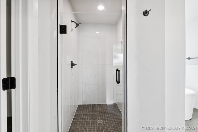 bathroom featuring a shower with shower door