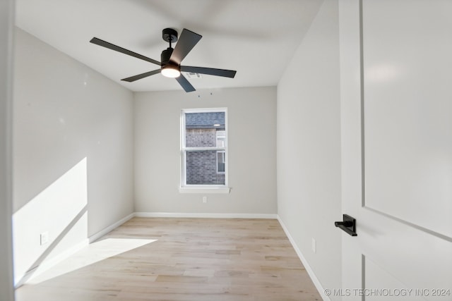 spare room featuring light hardwood / wood-style flooring and ceiling fan