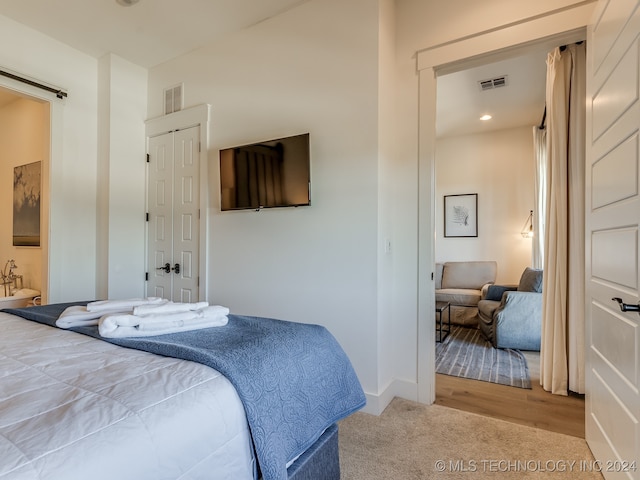 bedroom with light hardwood / wood-style floors