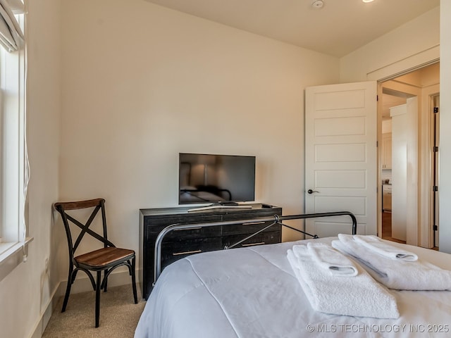 carpeted bedroom with baseboards